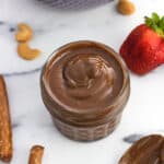 Orange Chocolate Cashew Butter is made in minutes in the food processor for a creamy and delicious spread with no sugar added. Sub it in for peanut or almond butter in sandwiches, or serve it as a perfect dip for fruit or pretzels!