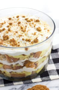 This pound cake trifle features salted honey, vanilla pudding, homemade stabilized (!) whipped cream, gingersnaps, and white chocolate sauce for a uniquely-flavored layered dessert. This make-ahead trifle is perfect for serving a crowd!