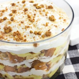 This pound cake trifle features salted honey, vanilla pudding, homemade stabilized (!) whipped cream, gingersnaps, and white chocolate sauce for a uniquely-flavored layered dessert. This make-ahead trifle is perfect for serving a crowd!
