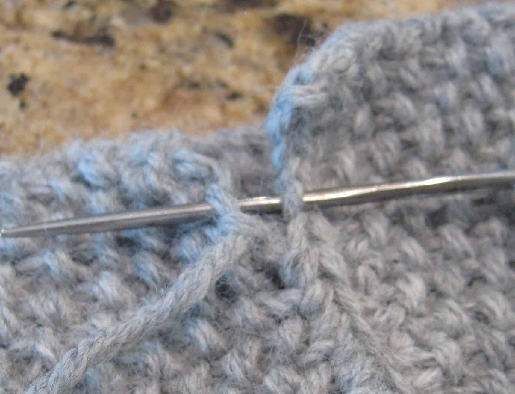 A metal sewing needle joining two edges of the headband.