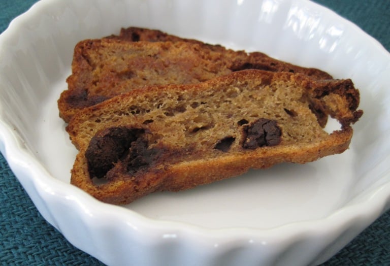 A toasted banana bread chip in a small ceramic bowl.