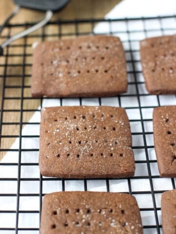 Chocolate grahams cooling on a wire rack next to a spatula