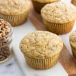 Banana nut muffins on a marble board with the recipe name on the image.