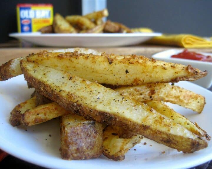 A pile of seasoned and baked potato wedges on a plate.