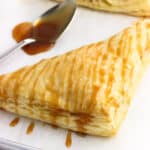 A caramel-drizzled turnover on a baking sheet.