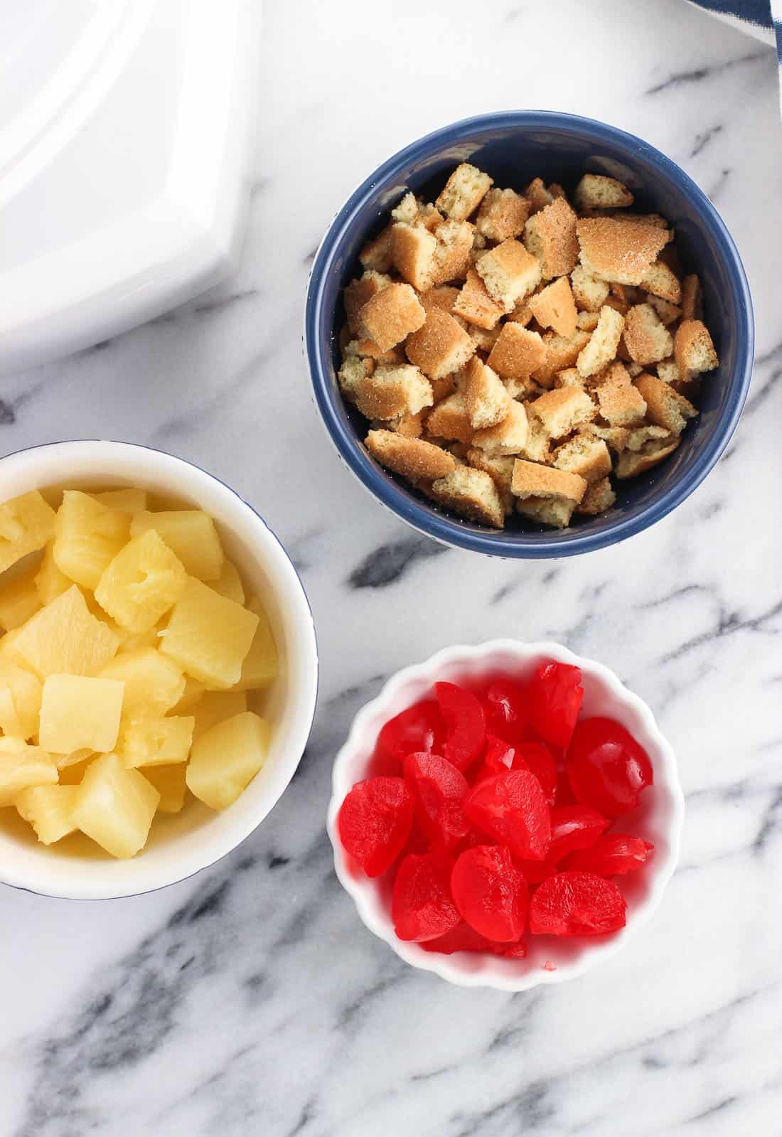 Recipe ingredients in separate bowls on a marble board.