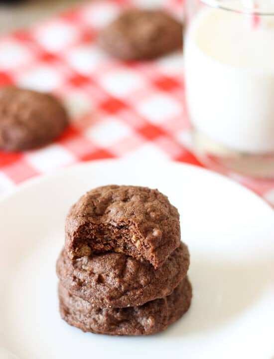 A stack of chocolate cookies on a plate.