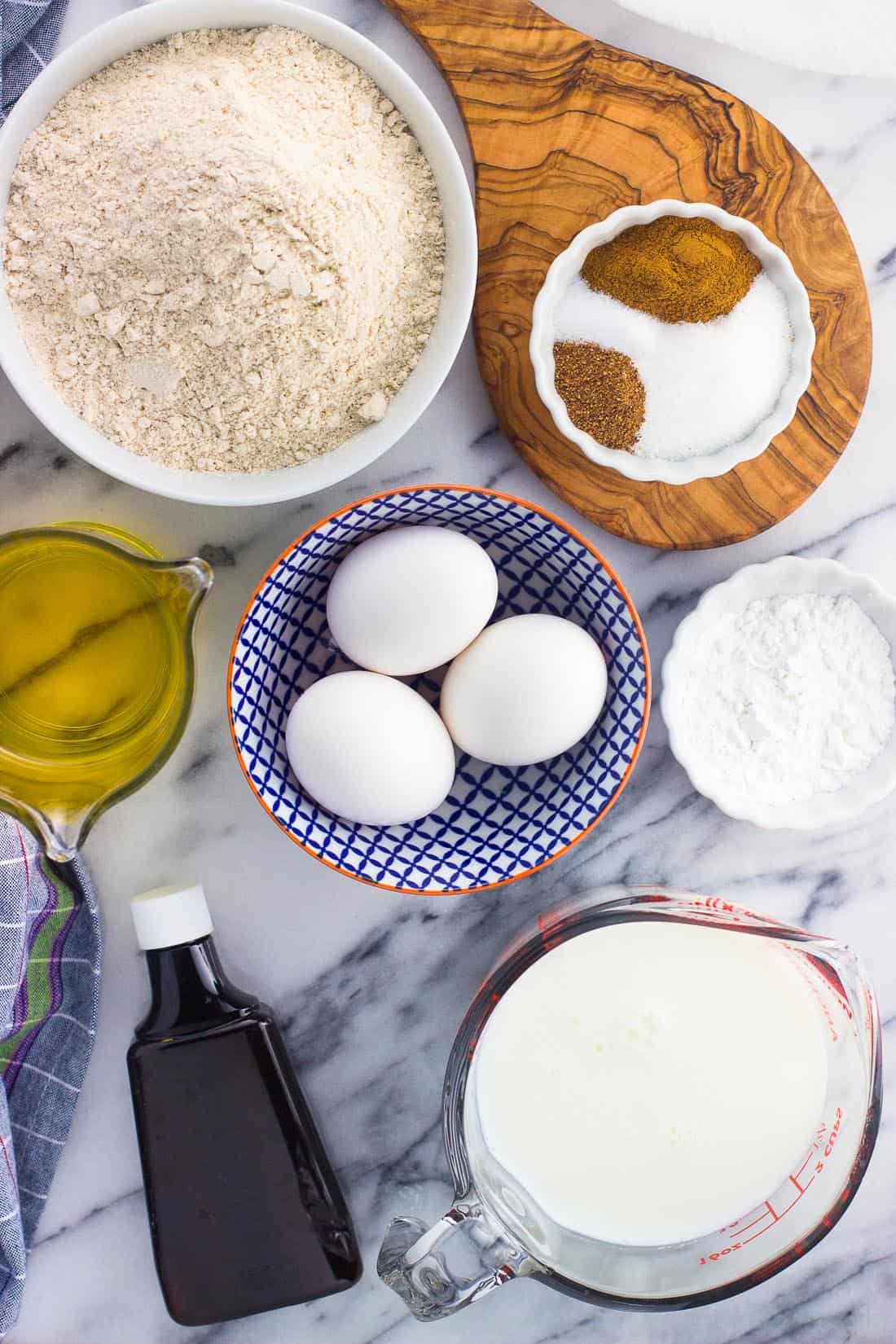 An overhead shot of all the ingredients in separate bowls on a marble board