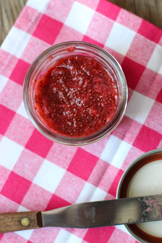 A jar of strawberry chia jam on a dish towel