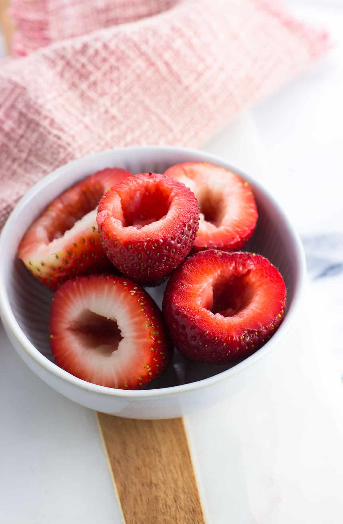 Hulled strawberries in a bowl.