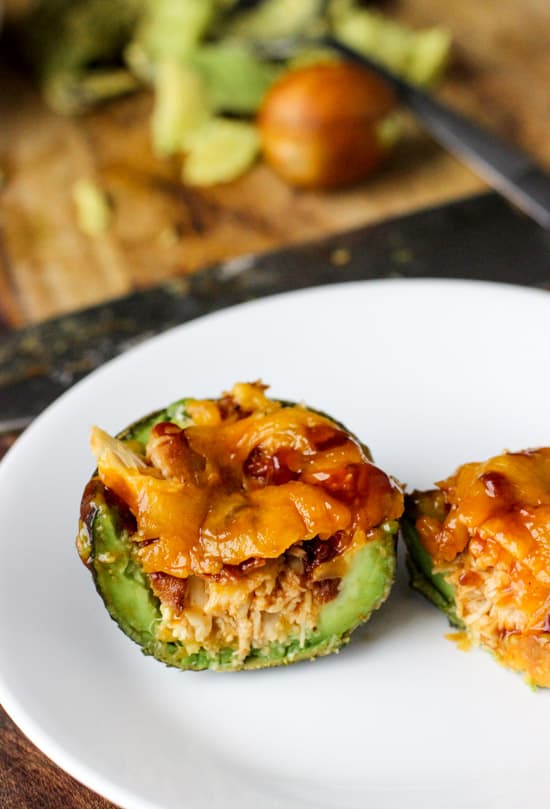 An avocado boat cut in half on a plate.