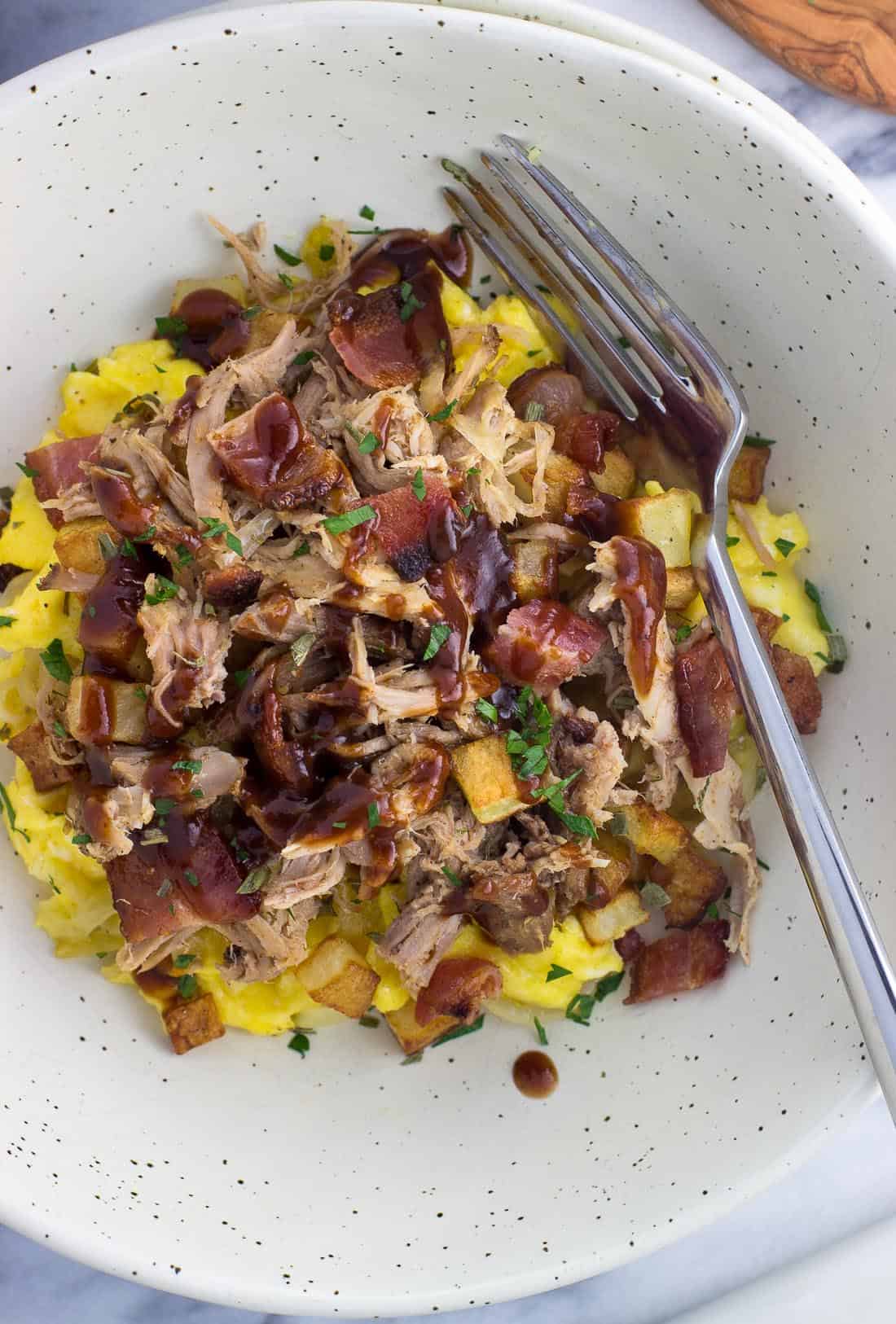 An overhead picture of the BBQ pulled pork breakfast bowl with a fork
