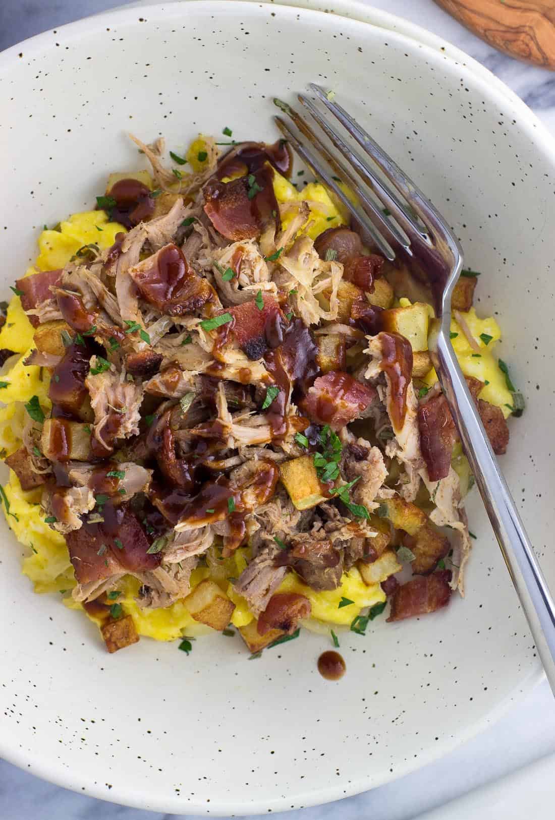 An overhead picture of the BBQ pulled pork breakfast bowl with a fork.