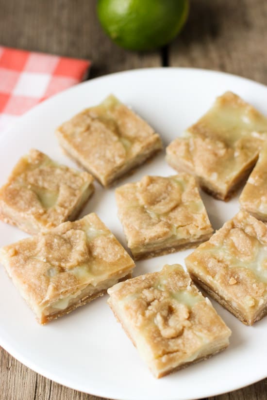 Lime curd bars arranged around a plate.
