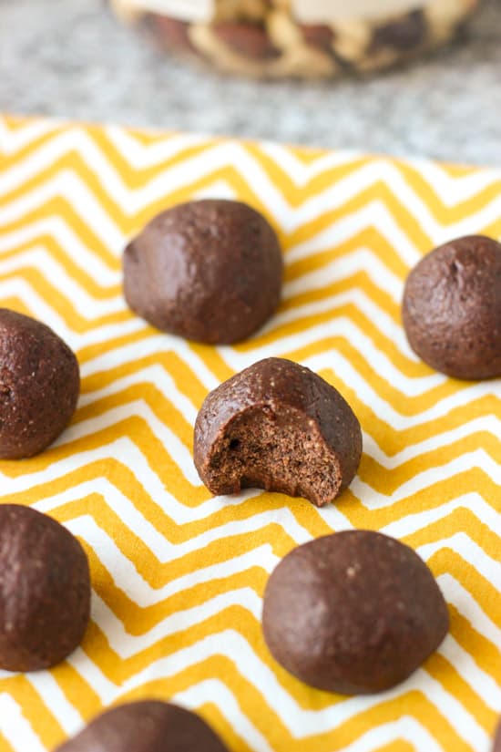 Trail mix bites on a linen placemat with a bite taken out of one.