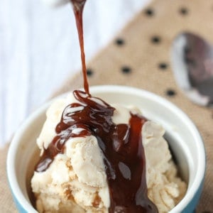 Caramel sauce drizzled over top of a small bowl of ice cream.