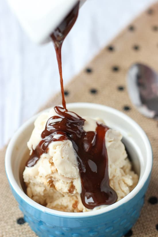 Caramel sauce drizzled over top of a small bowl of ice cream.