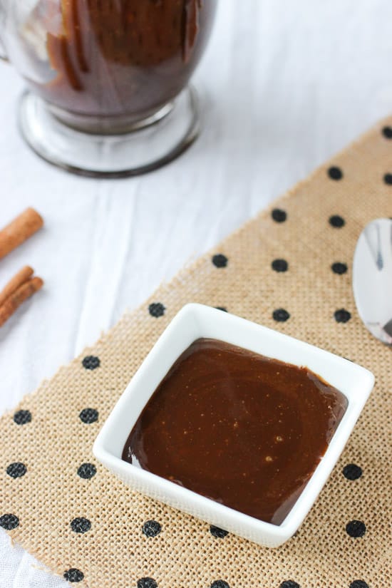 A small ramekin filled with caramel sauce.