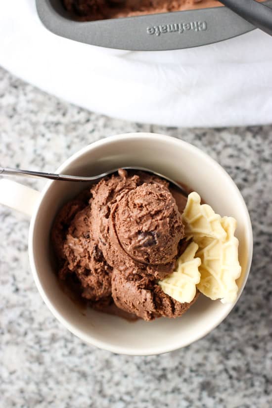 A close-up of ice cream in a bowl with pizzelle pieces.