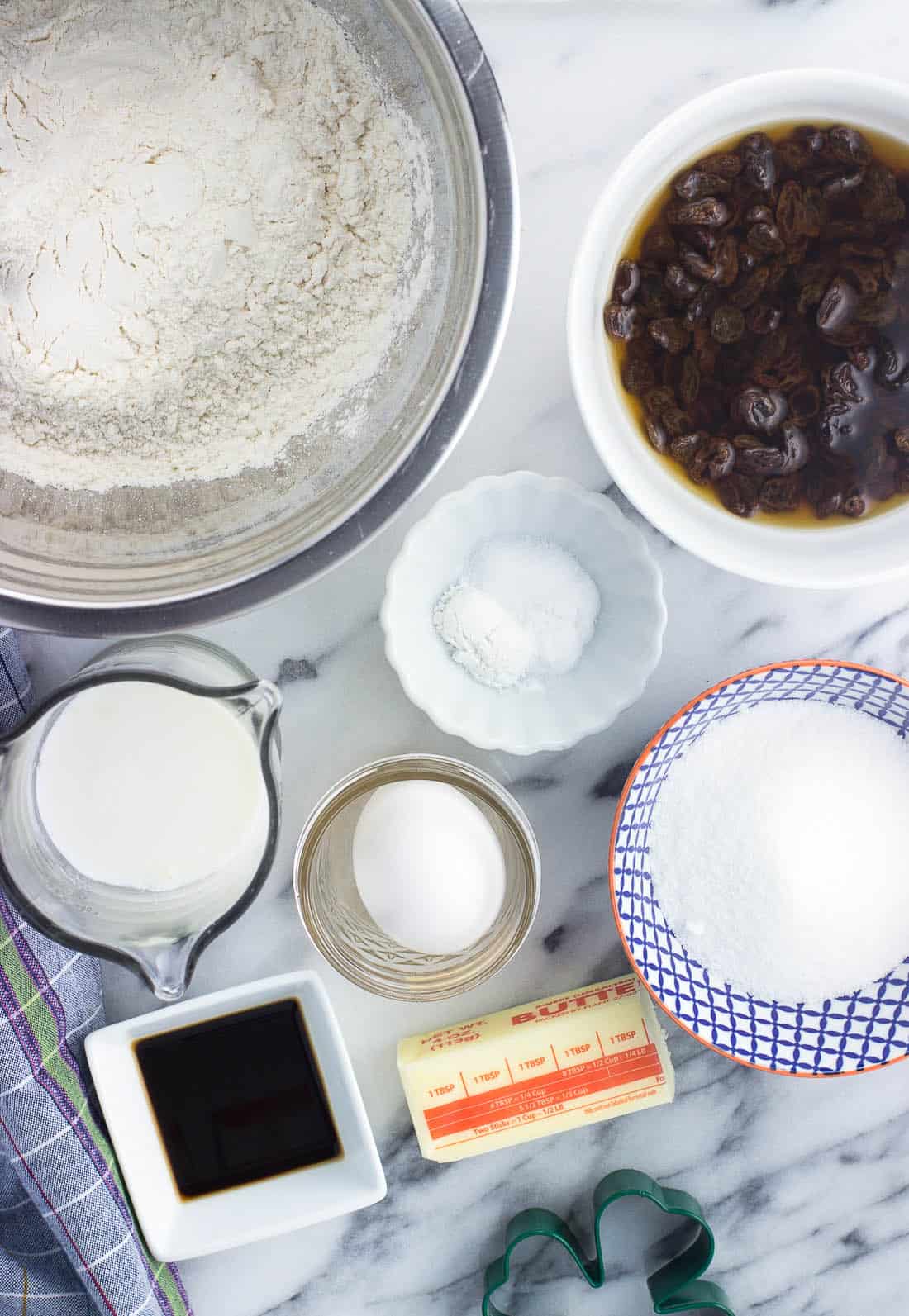 Maple Irish soda bread ingredients in separate bowls on a marble board.