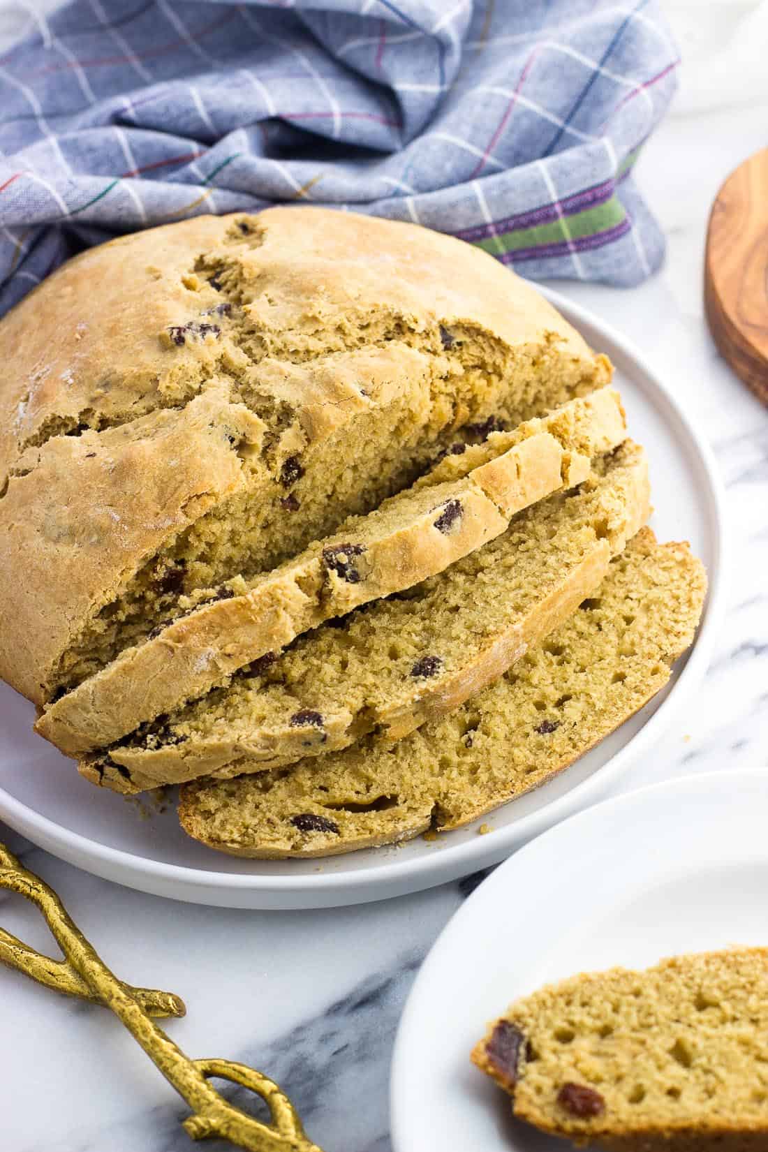 A loaf of maple Irish soda bread halfway sliced.