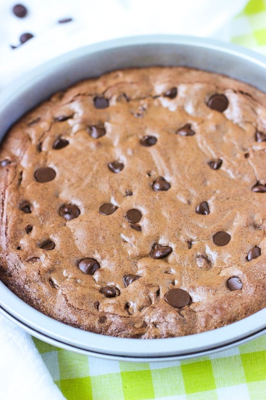 Baked brownie cake in a round cake pan.