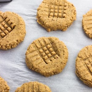 Peanut butter cookies on a sheet of parchment paper.