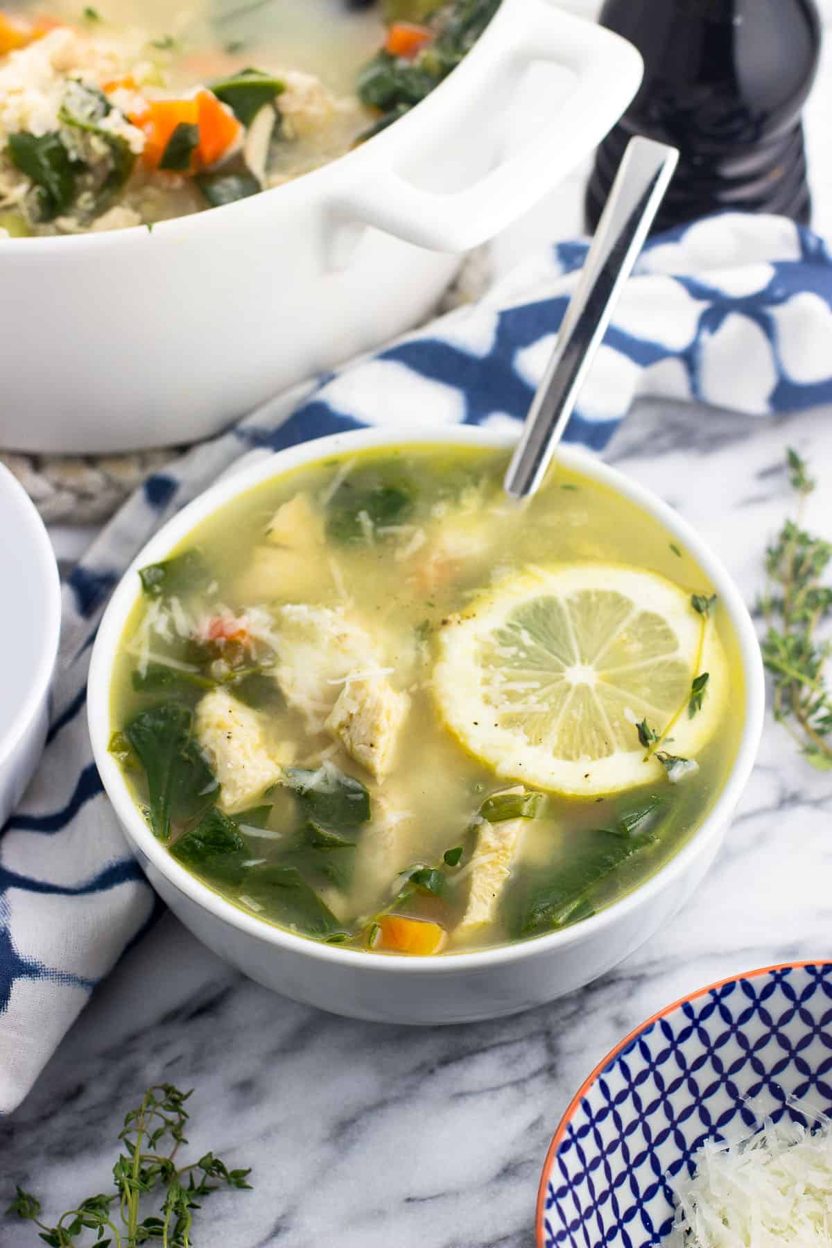 A bowl of soup with a spoon ready to serve