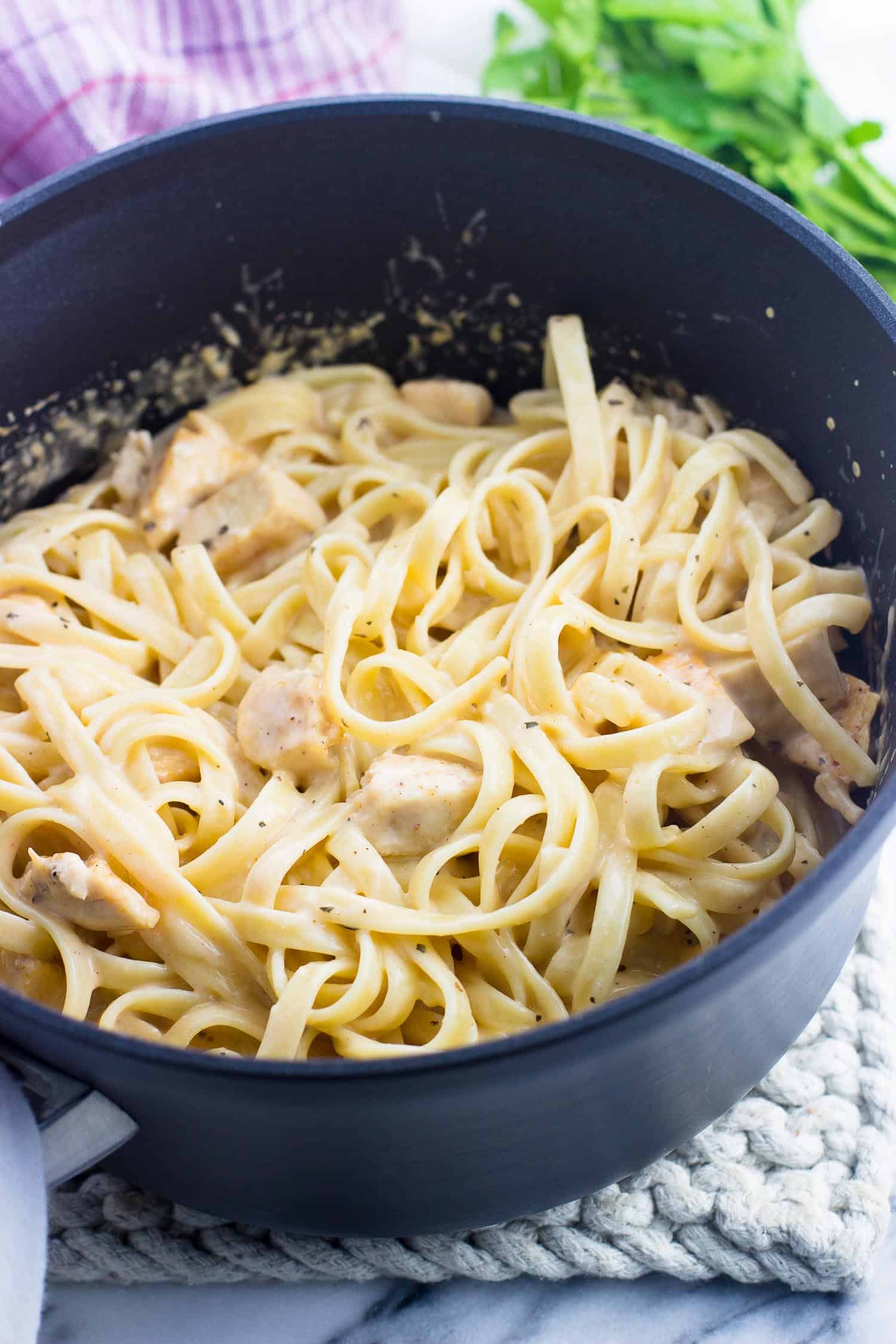 Lightened up buffalo chicken alfredo pasta in a saucepan