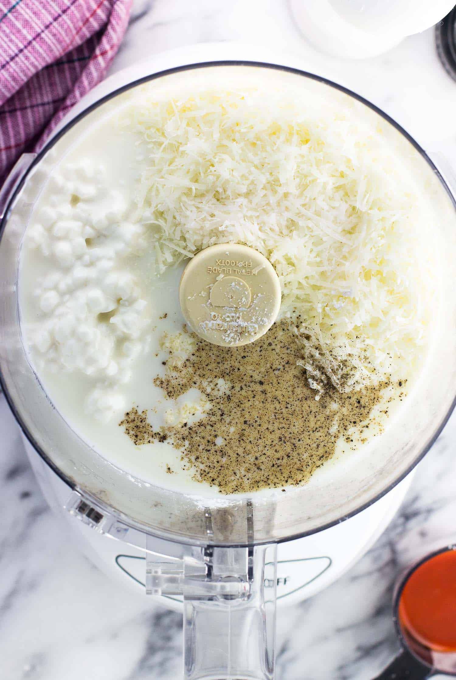 Lightened up alfredo sauce ingredients in a food processor before blending