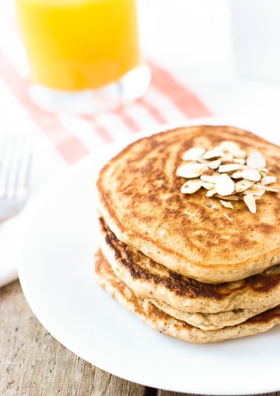 A close-up of three thick pancakes stacked on a plate.