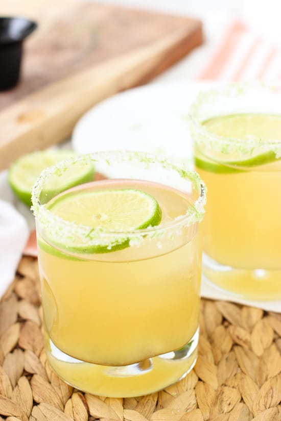 Two beer margaritas on a woven placemat  