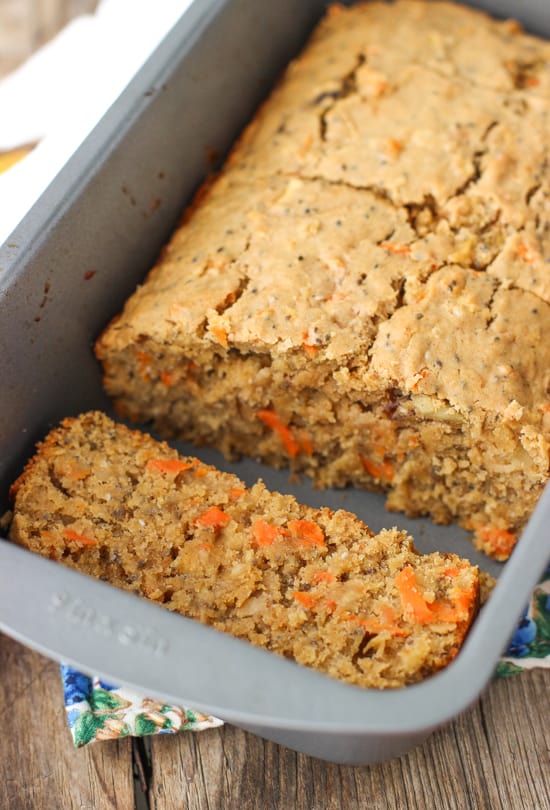 Sliced morning glory bread in a metal loaf pan.