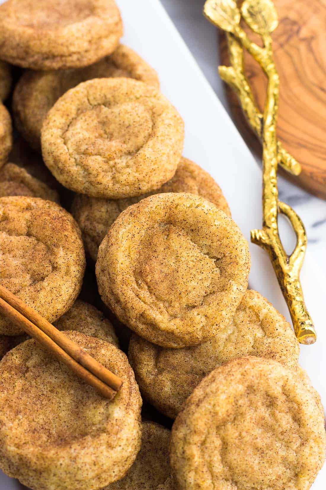 A tray of snickerdoodles with a cinnamon stick next to it