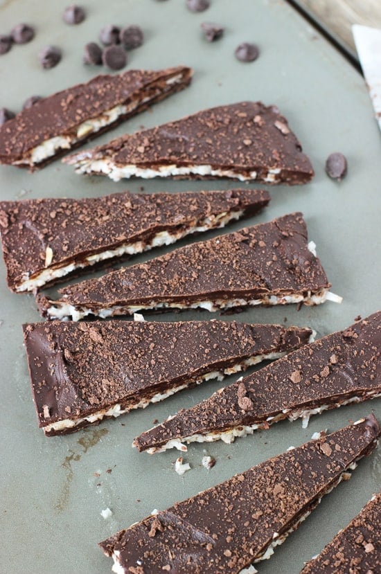 Assorted pieces of almond joy bark arranged on a metal baking sheet.