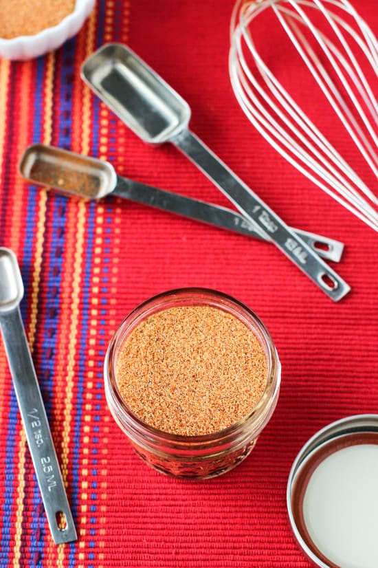 An overhead shot of the jar of spice mix on a cloth placemat