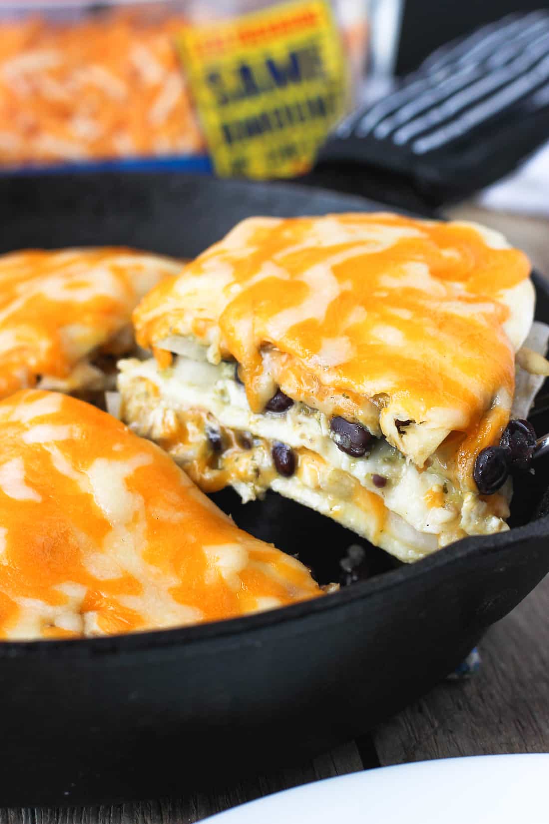 A wedge of tortilla pie being lifted out of the pan by a spatula.