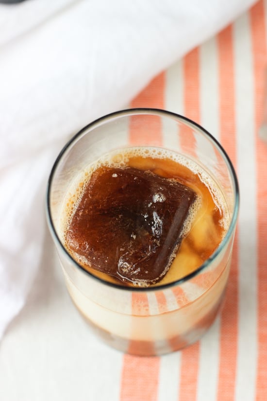 A top-down look at a glass of an iced chai latte.