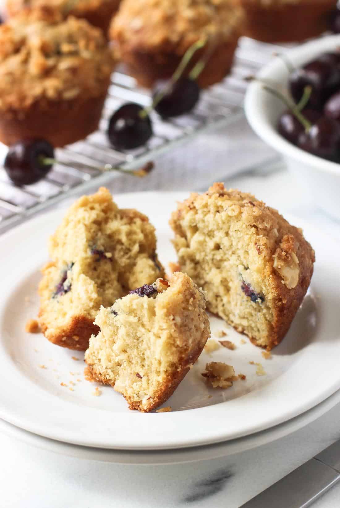 A muffin on a small dessert plate cut in half and then one half into quarters