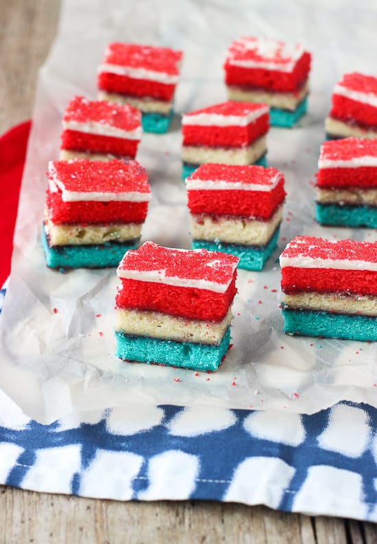 Sliced rainbow cookies on a piece of parchment paper