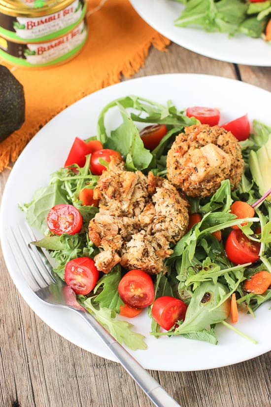 Tuna cake salad on a plate with a fork.