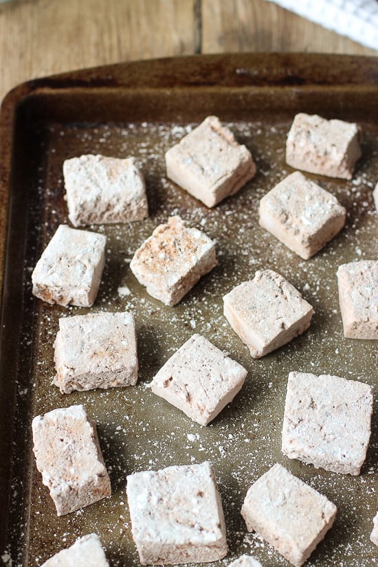 Scattered marshmallows on a metal baking sheet.