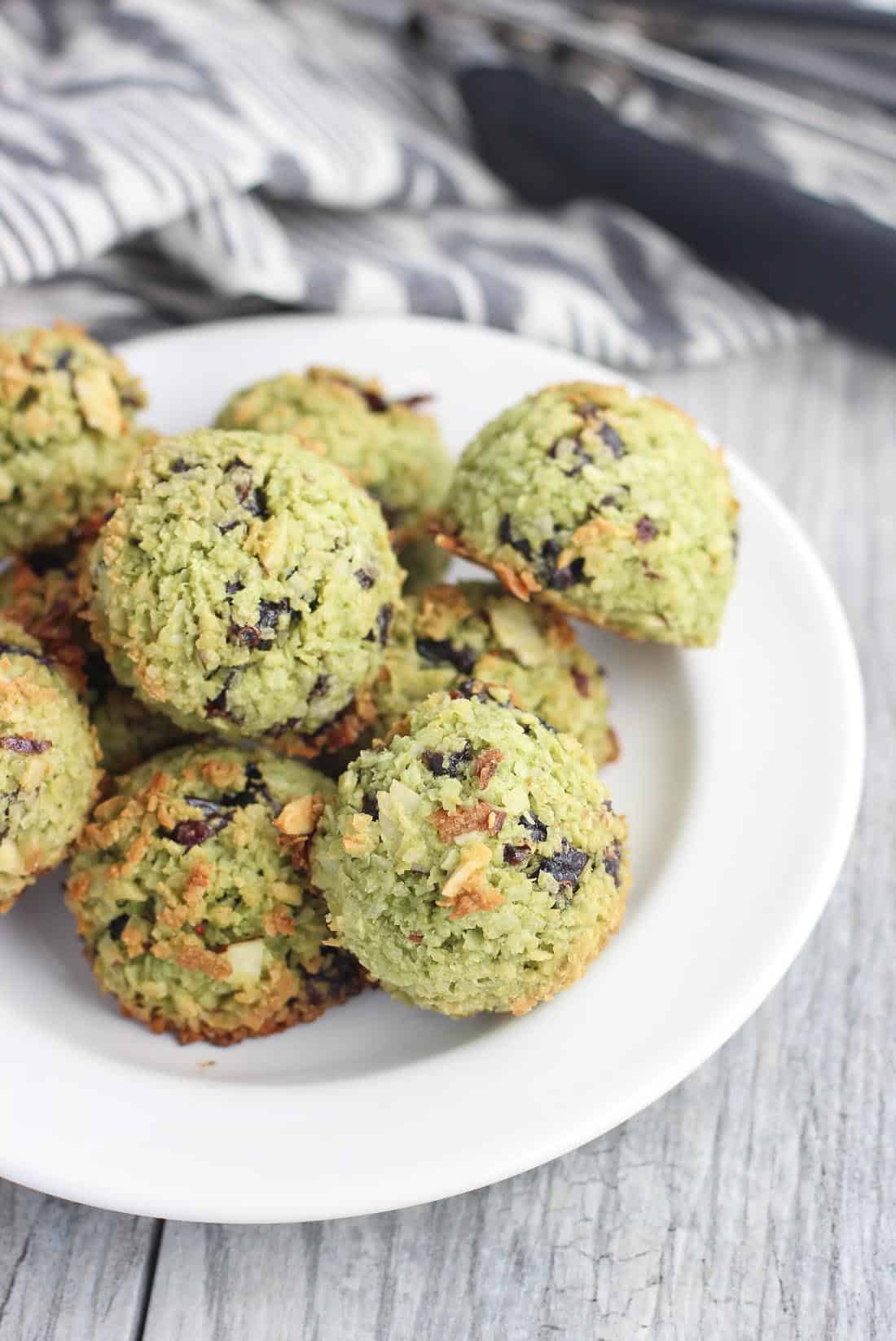 A batch of matcha macaroons on a small dessert plate.