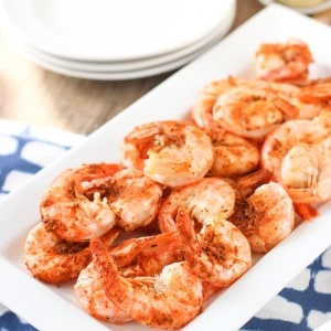 Steamed tail- and shell-on shrimp on a rectangular tray.