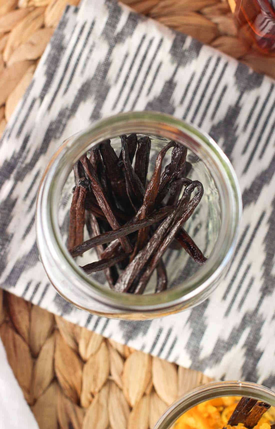 Whole vanilla beans in a large glass jar.