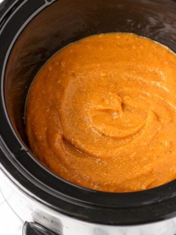 Pureed sweet potato soup in a slow cooker.