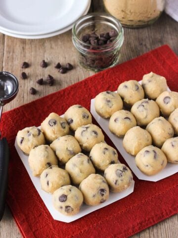 Two trays of rolled raw cookie dough balls.