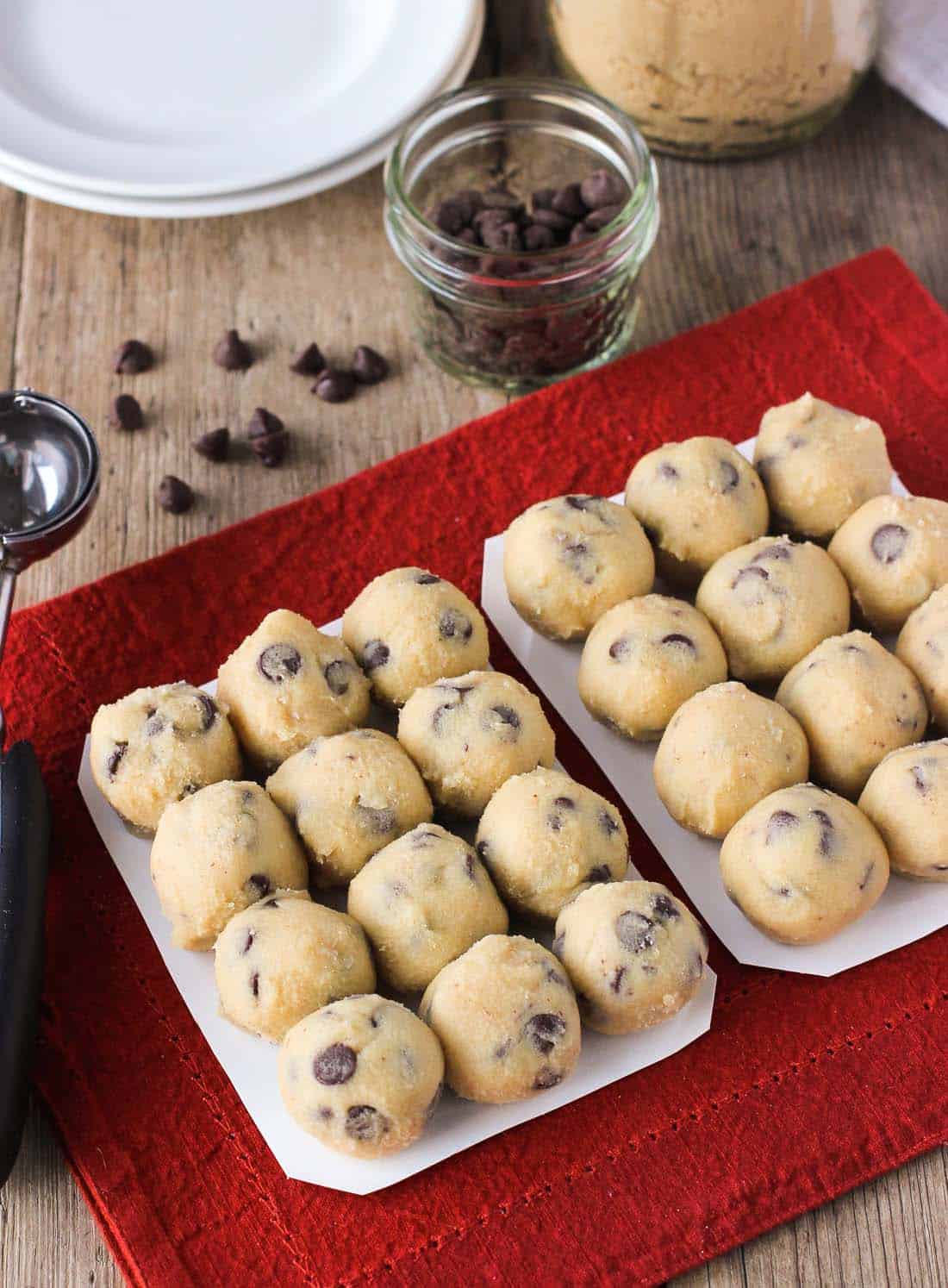 Two trays of rolled raw cookie dough balls.