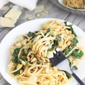 A fork twirled into a serving of pasta on a plate.