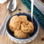 A bowl of ice cream with a spoon in it.